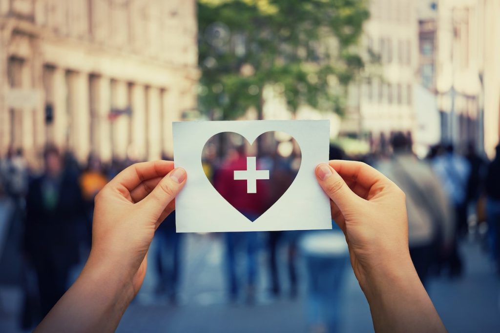 hands holding up a heart representing full body health and functional medicine